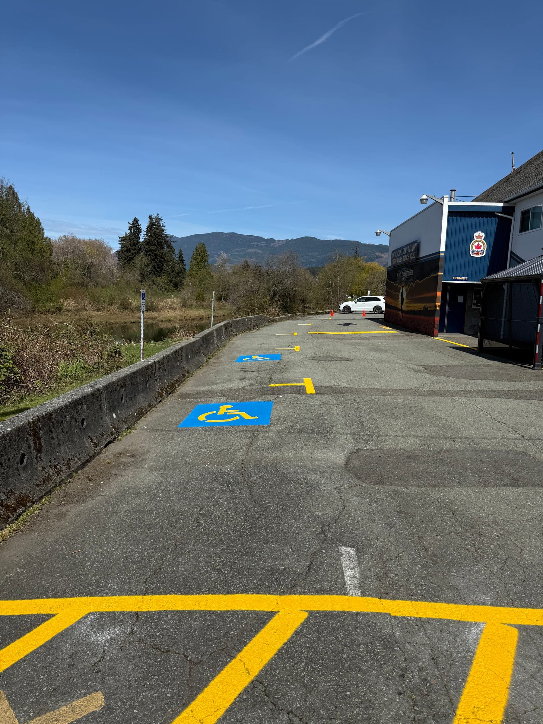 After photo of fresh accessible parking markings and yellow stall lines.