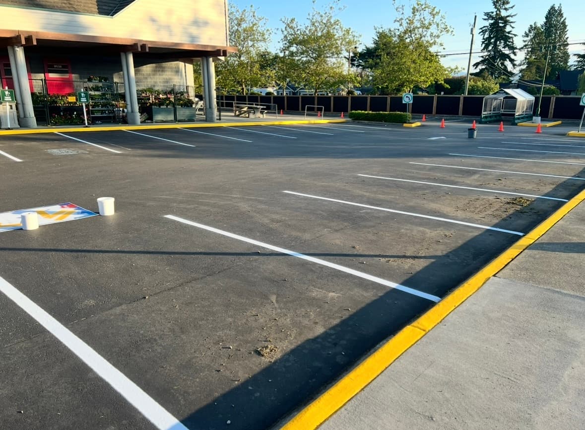Freshly painted parking lot with accessible stalls and directional arrows